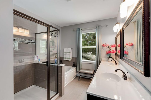 bathroom featuring a sink, a garden tub, a stall shower, and double vanity