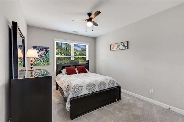 carpeted bedroom featuring baseboards, ceiling fan, and visible vents