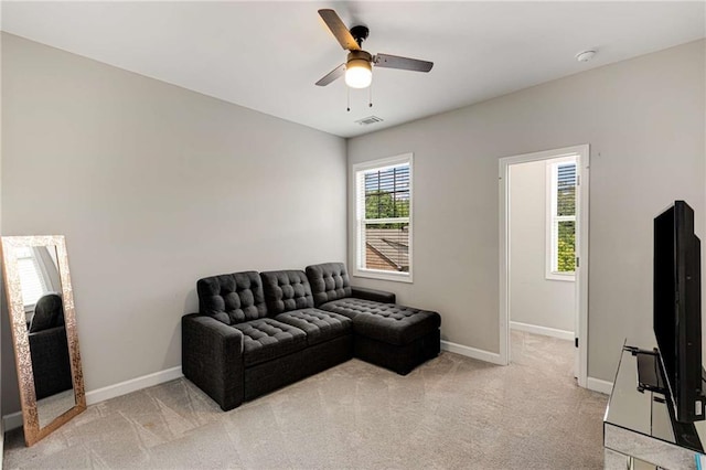 sitting room featuring light colored carpet, a ceiling fan, baseboards, and visible vents