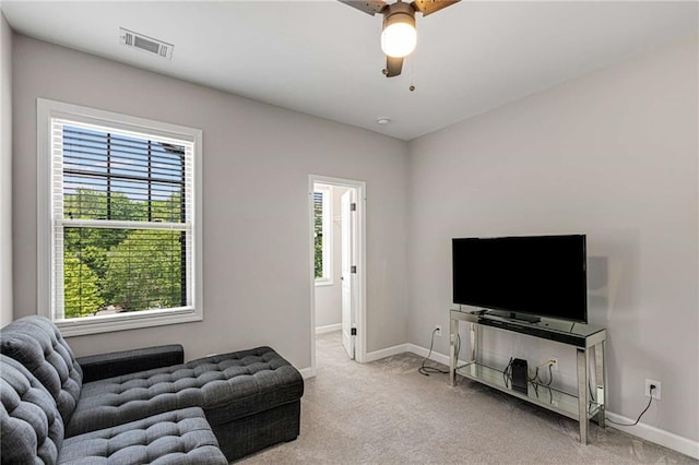 living room featuring a healthy amount of sunlight, baseboards, and visible vents