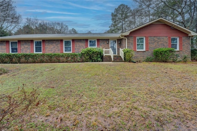 ranch-style house with a front lawn and brick siding