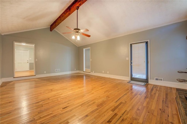 foyer with a textured ceiling, light wood-style flooring, baseboards, and ornamental molding