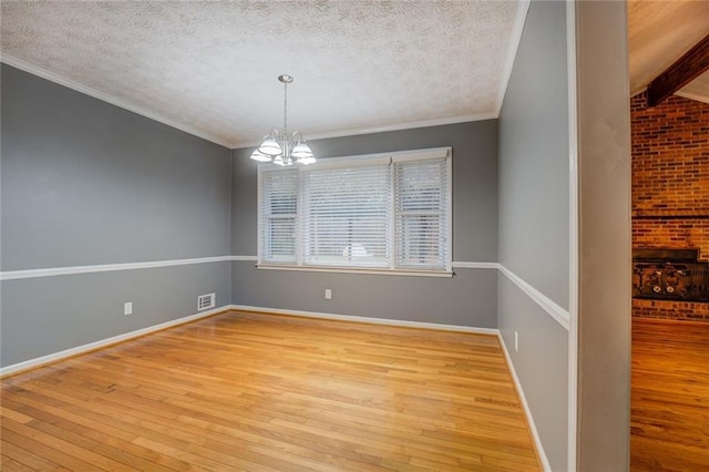 unfurnished living room with light wood-style floors, ceiling fan, baseboards, and crown molding