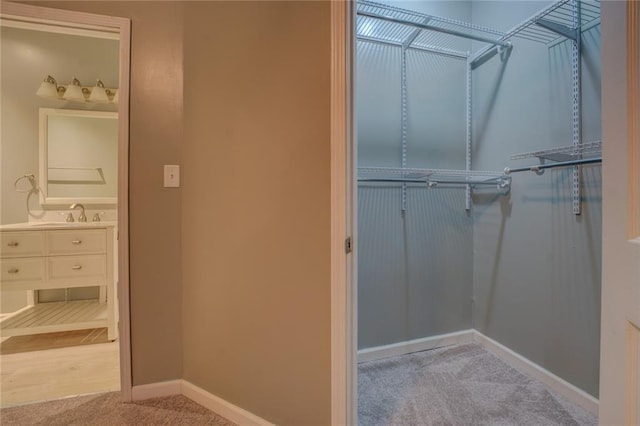 unfurnished room featuring attic access, light carpet, baseboards, a textured ceiling, and a ceiling fan