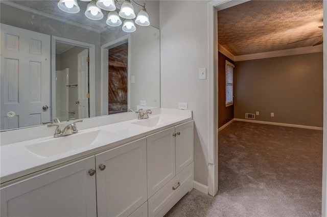 carpeted spare room featuring a ceiling fan, a textured ceiling, crown molding, and baseboards