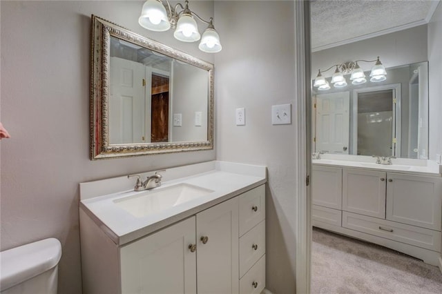 unfurnished bedroom featuring carpet flooring, a textured ceiling, a walk in closet, baseboards, and ceiling fan