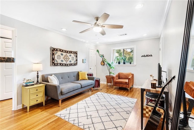 living area featuring ceiling fan, crown molding, light wood-type flooring, recessed lighting, and baseboards