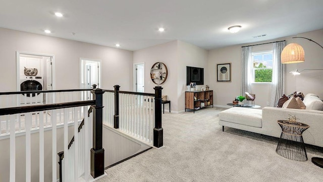 interior space featuring recessed lighting, visible vents, baseboards, and light colored carpet