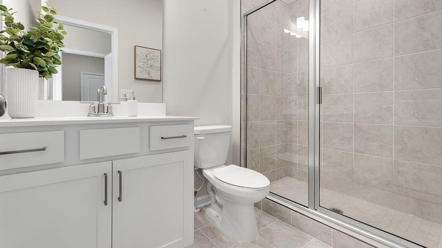 full bathroom featuring toilet, a stall shower, tile patterned floors, and vanity