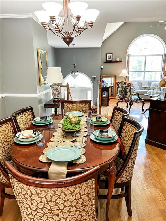3809 Autumn View Ln NW, Acworth, GA 30101 - dining area with a chandelier, light wood-style floors, vaulted ceiling, and a ceiling fan