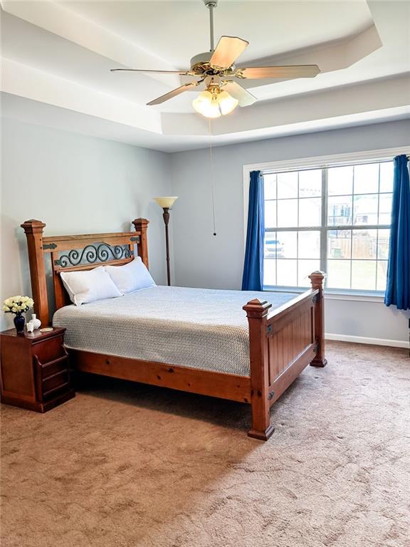 3809 Autumn View Ln NW, Acworth, GA 30101 - bedroom featuring a tray ceiling, carpet floors, and ceiling fan