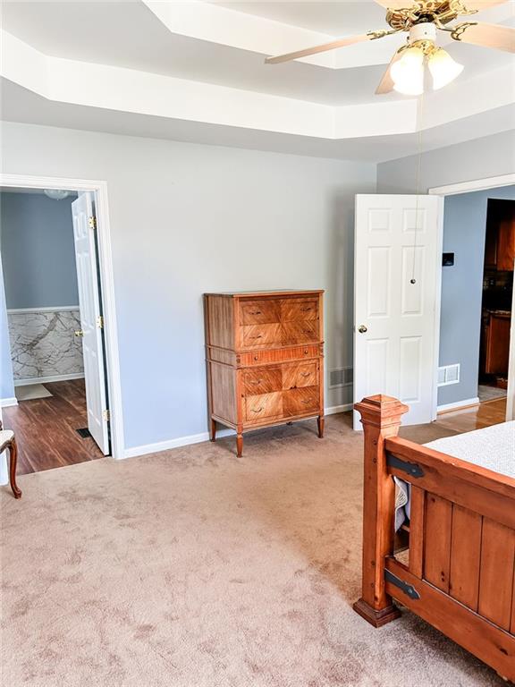 3809 Autumn View Ln NW, Acworth, GA 30101 - carpeted bedroom featuring a tray ceiling and a ceiling fan