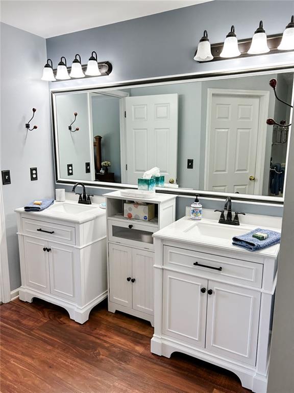 3809 Autumn View Ln NW, Acworth, GA 30101 - bathroom featuring two vanities and wood finished floors