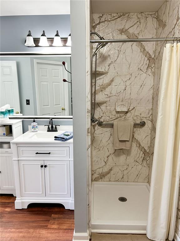 3809 Autumn View Ln NW, Acworth, GA 30101 - bathroom with a stall shower, vanity, and wood finished floors