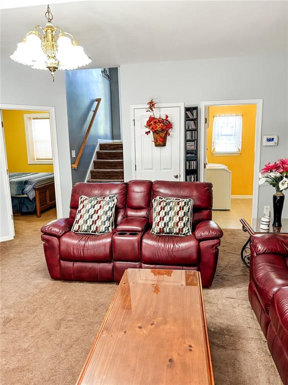 3809 Autumn View Ln NW, Acworth, GA 30101 - living area featuring a chandelier, carpet flooring, stairway, and washer / clothes dryer