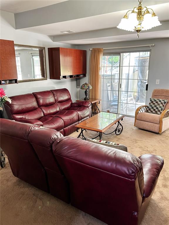 3809 Autumn View Ln NW, Acworth, GA 30101 - carpeted living area with a chandelier