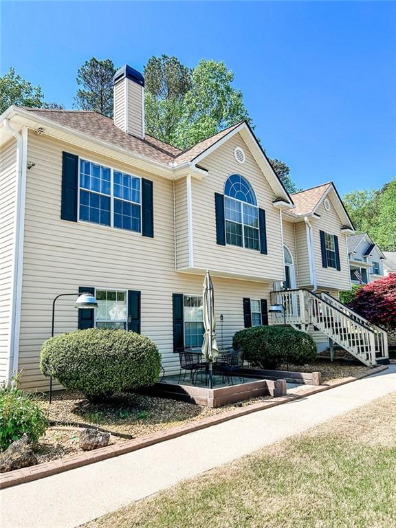 3809 Autumn View Ln NW, Acworth, GA 30101 - bi-level home with a chimney and a patio area