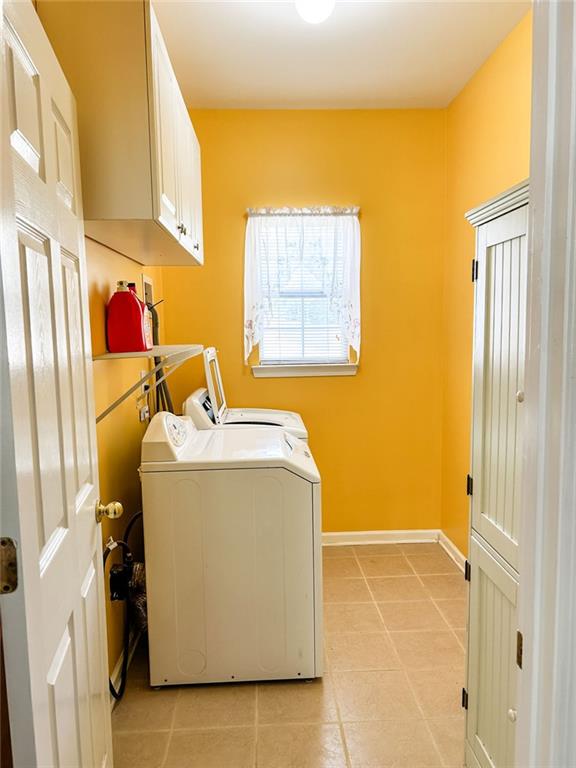 3809 Autumn View Ln NW, Acworth, GA 30101 - washroom with cabinet space, light tile patterned floors, and washer and dryer