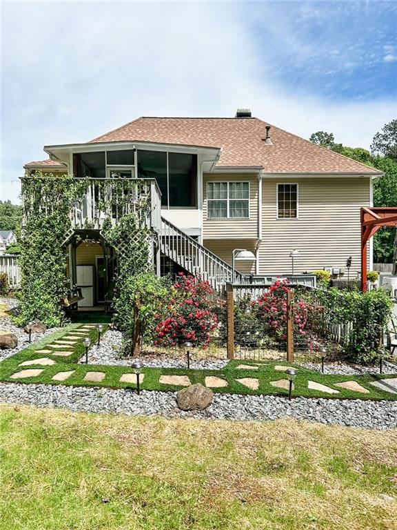 3809 Autumn View Ln NW, Acworth, GA 30101 - back of house featuring stairway, a sunroom, and a shingled roof