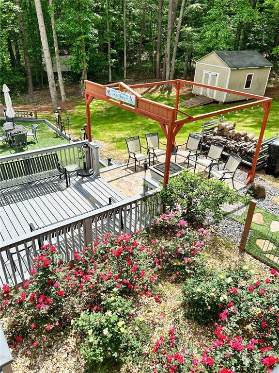 3809 Autumn View Ln NW, Acworth, GA 30101 - surrounding community with a wooden deck, a lawn, and a storage shed