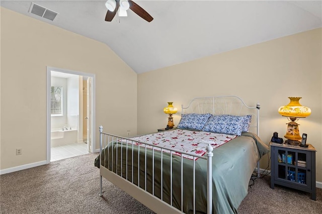 carpeted bedroom featuring visible vents, a ceiling fan, connected bathroom, baseboards, and vaulted ceiling