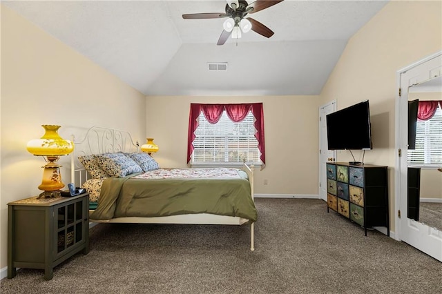 bedroom with visible vents, multiple windows, carpet, and lofted ceiling