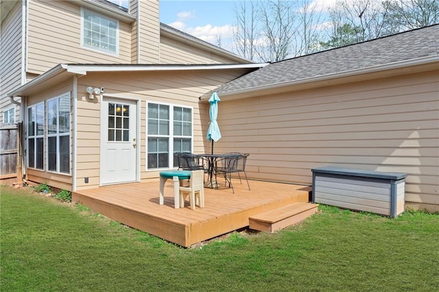 deck with a yard and outdoor dining space