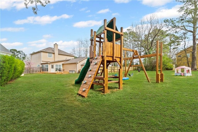 view of play area featuring a lawn and fence