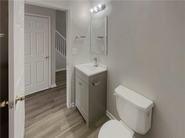 6941 Gallant Cir SE Unit 10, Mableton, GA 30126 - bathroom featuring baseboards, wood finished floors, toilet, and vanity