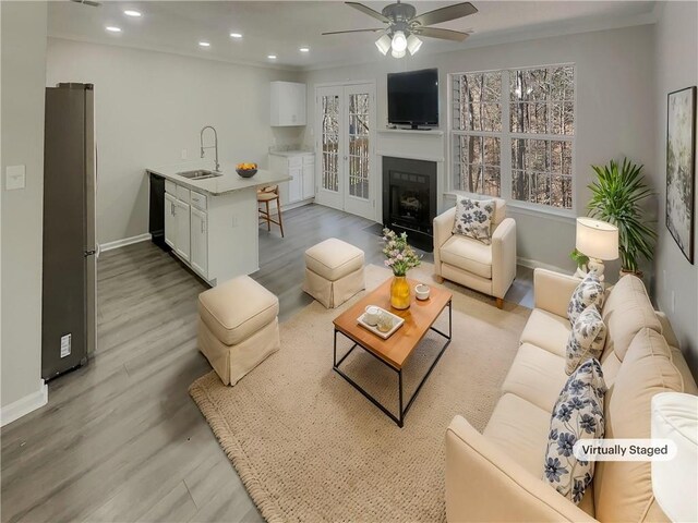 6941 Gallant Cir SE Unit 10, Mableton, GA 30126 - living area featuring a fireplace with flush hearth, baseboards, light wood-style floors, ceiling fan, and recessed lighting
