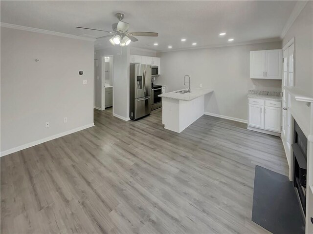 6941 Gallant Cir SE Unit 10, Mableton, GA 30126 - kitchen with crown molding, a sink, a peninsula, stainless steel appliances, and white cabinets