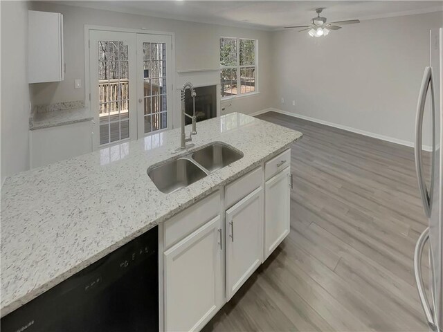 6941 Gallant Cir SE Unit 10, Mableton, GA 30126 - kitchen with a sink, freestanding refrigerator, wood finished floors, black dishwasher, and ceiling fan