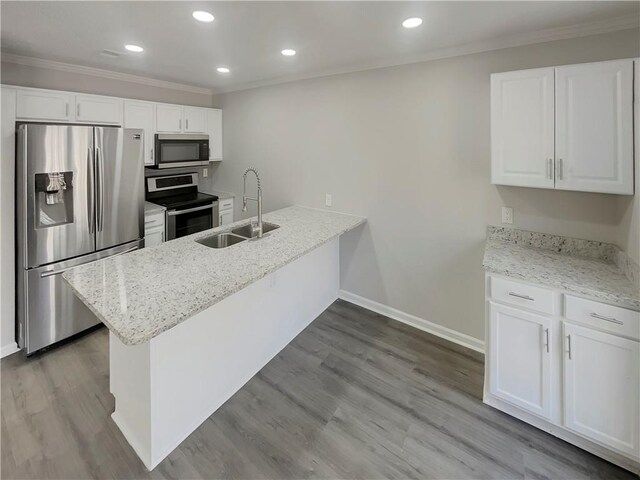 6941 Gallant Cir SE Unit 10, Mableton, GA 30126 - kitchen with a sink, white cabinetry, wood finished floors, appliances with stainless steel finishes, and ornamental molding