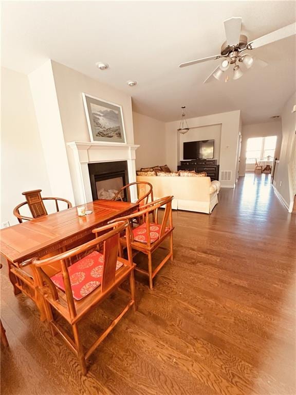 4438 Lassen Ct, Suwanee, GA 30024 - dining room with wood finished floors, a fireplace, and ceiling fan