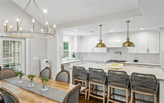 dining space featuring washer / dryer, lofted ceiling, sink, and dark wood-type flooring