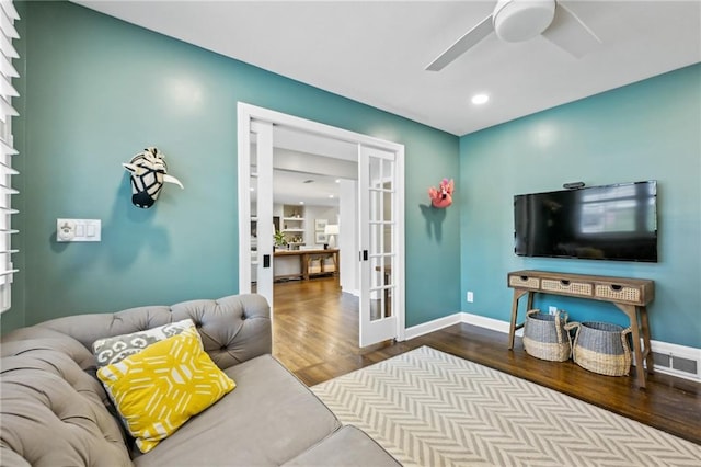 living room featuring hardwood / wood-style floors, french doors, and ceiling fan