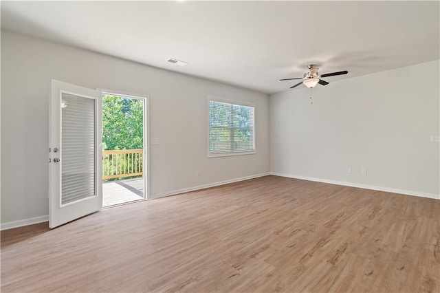 empty room featuring ceiling fan and light hardwood / wood-style floors