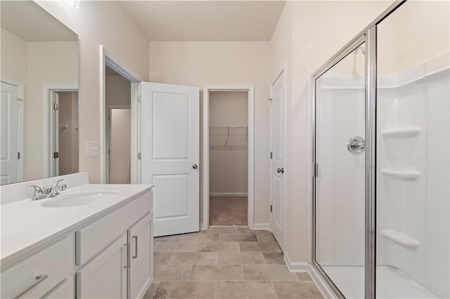 bathroom with vanity and a shower with shower door