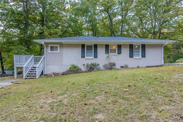 ranch-style home with a front lawn