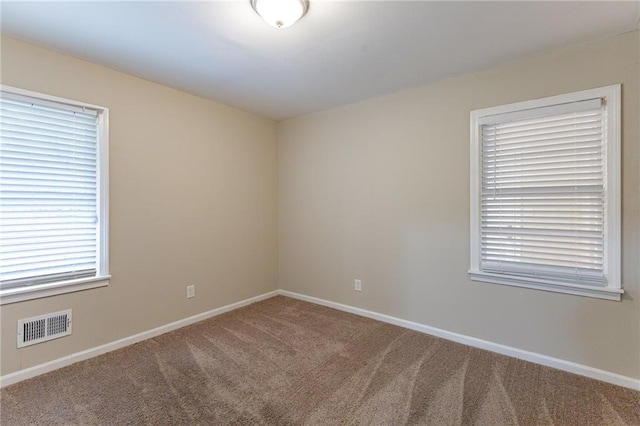 unfurnished room featuring carpet