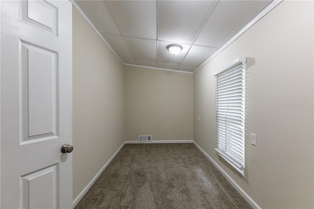 unfurnished room featuring crown molding and dark colored carpet