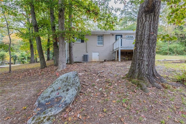 rear view of property featuring a deck and central AC unit