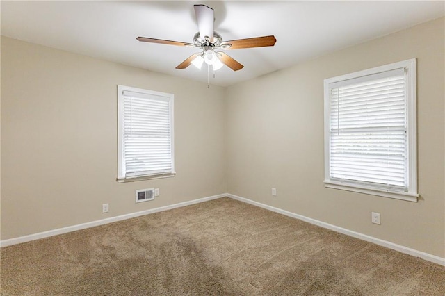 spare room with carpet floors and ceiling fan