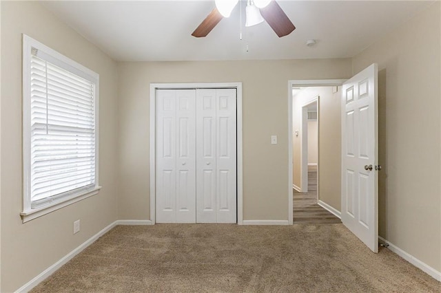 unfurnished bedroom with a closet, carpet flooring, and ceiling fan