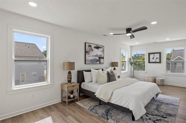 bedroom featuring baseboards, recessed lighting, a ceiling fan, and wood finished floors