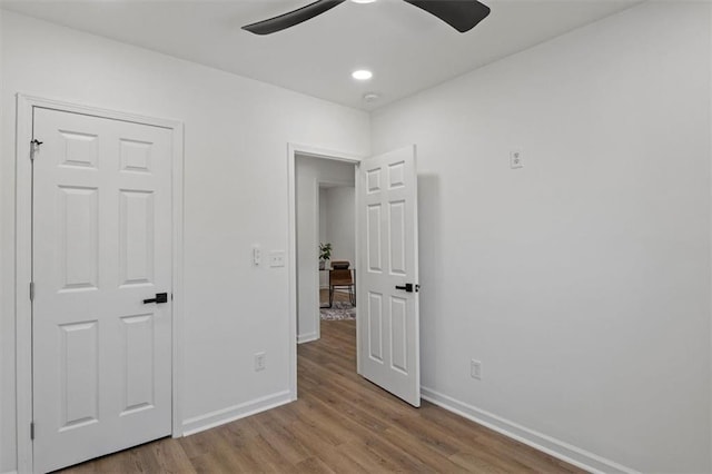 unfurnished bedroom with baseboards, ceiling fan, recessed lighting, and wood finished floors