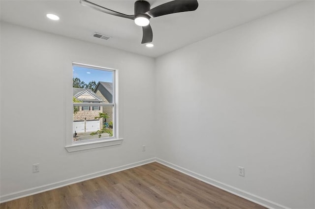 empty room with wood finished floors, a ceiling fan, visible vents, baseboards, and recessed lighting