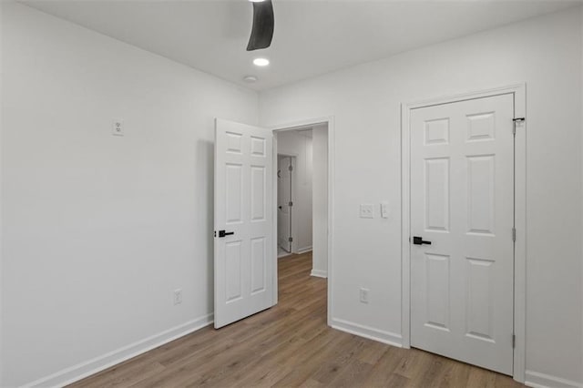unfurnished bedroom with wood finished floors, baseboards, ceiling fan, and recessed lighting