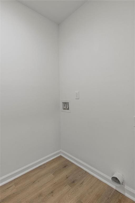 washroom featuring laundry area, light wood-style floors, baseboards, and hookup for a washing machine