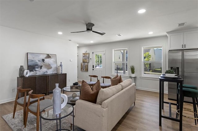 living area featuring visible vents, wood finished floors, a ceiling fan, and recessed lighting